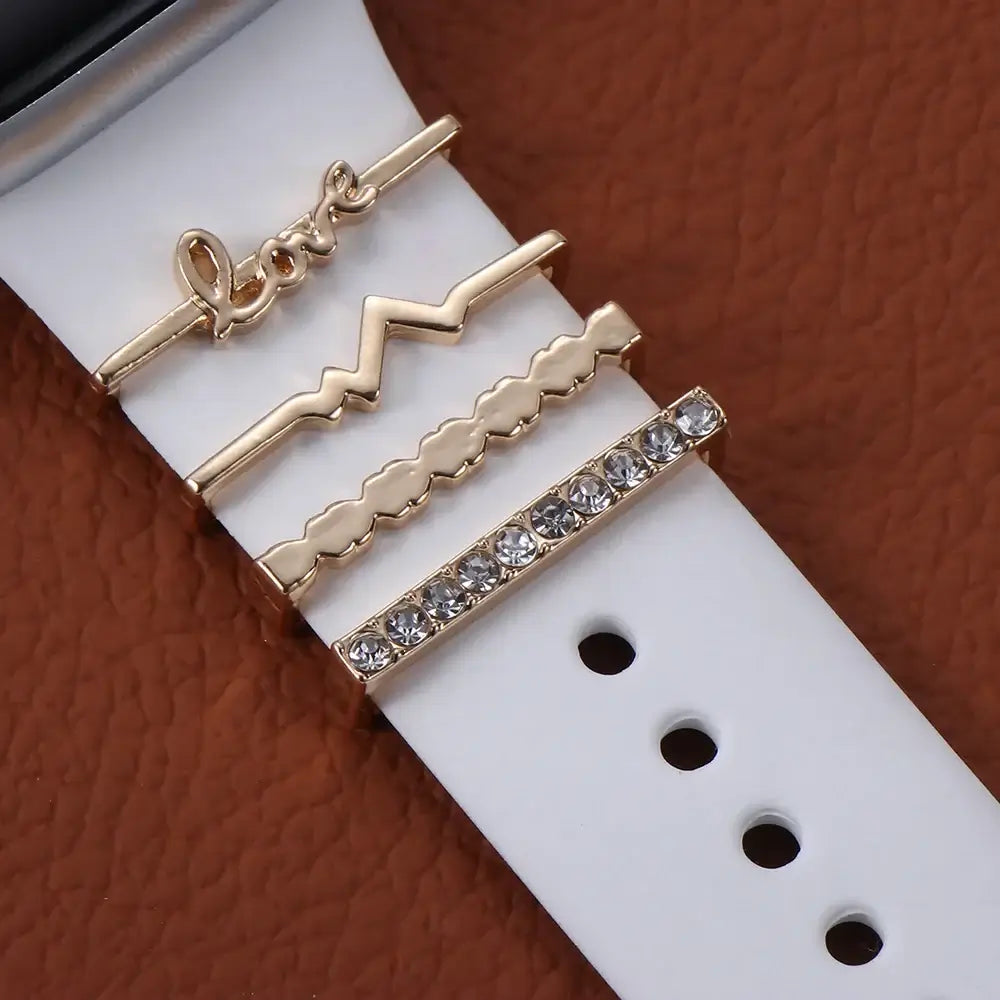 Decorative metal charms on Apple Watch band, showcasing elegance and style with sparkling designs.