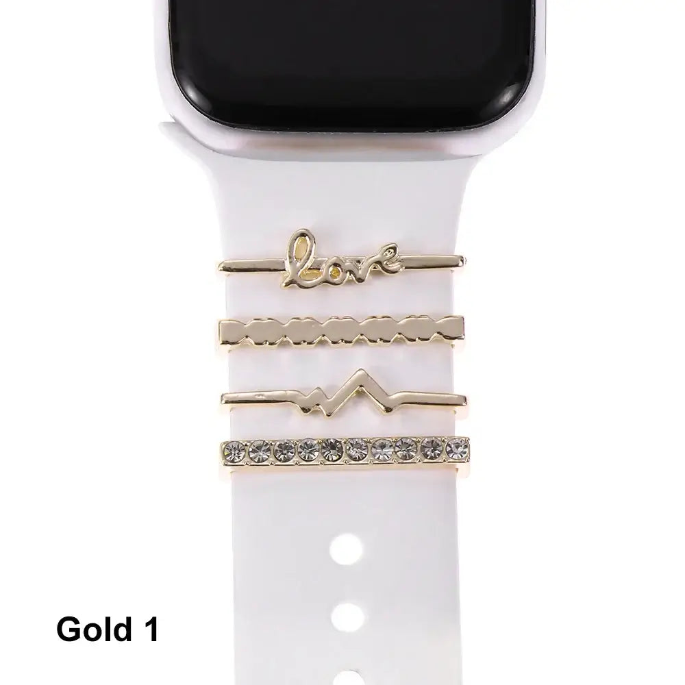 Decorative gold metal charms on a white Apple Watch band, enhancing style and sophistication. Perfect for any outfit.