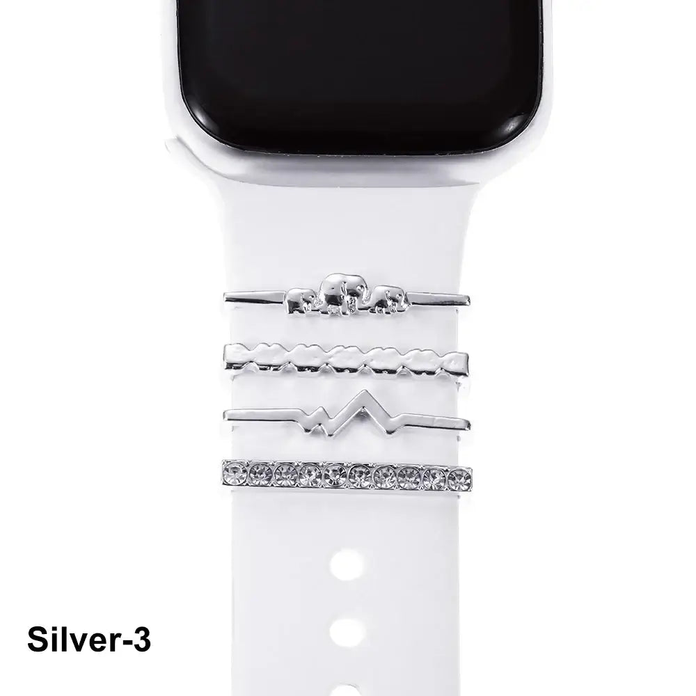 Decorative silver metal charms on a white Apple Watch band, showcasing stylish sophistication and craftsmanship.