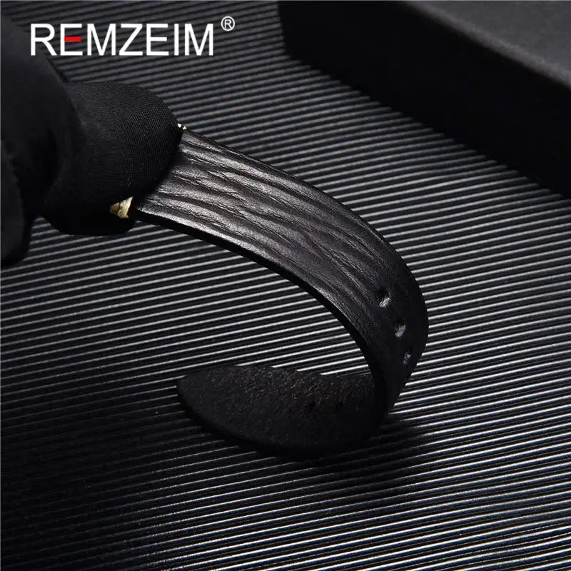 Close-up of a textured black leather Suunto watch band by REMZEIM, showcasing its quality and durability.