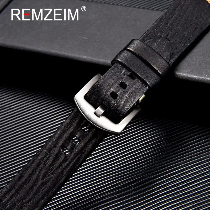 Close-up of a textured black leather watch band featuring a silver buckle, perfect for Suunto watches.