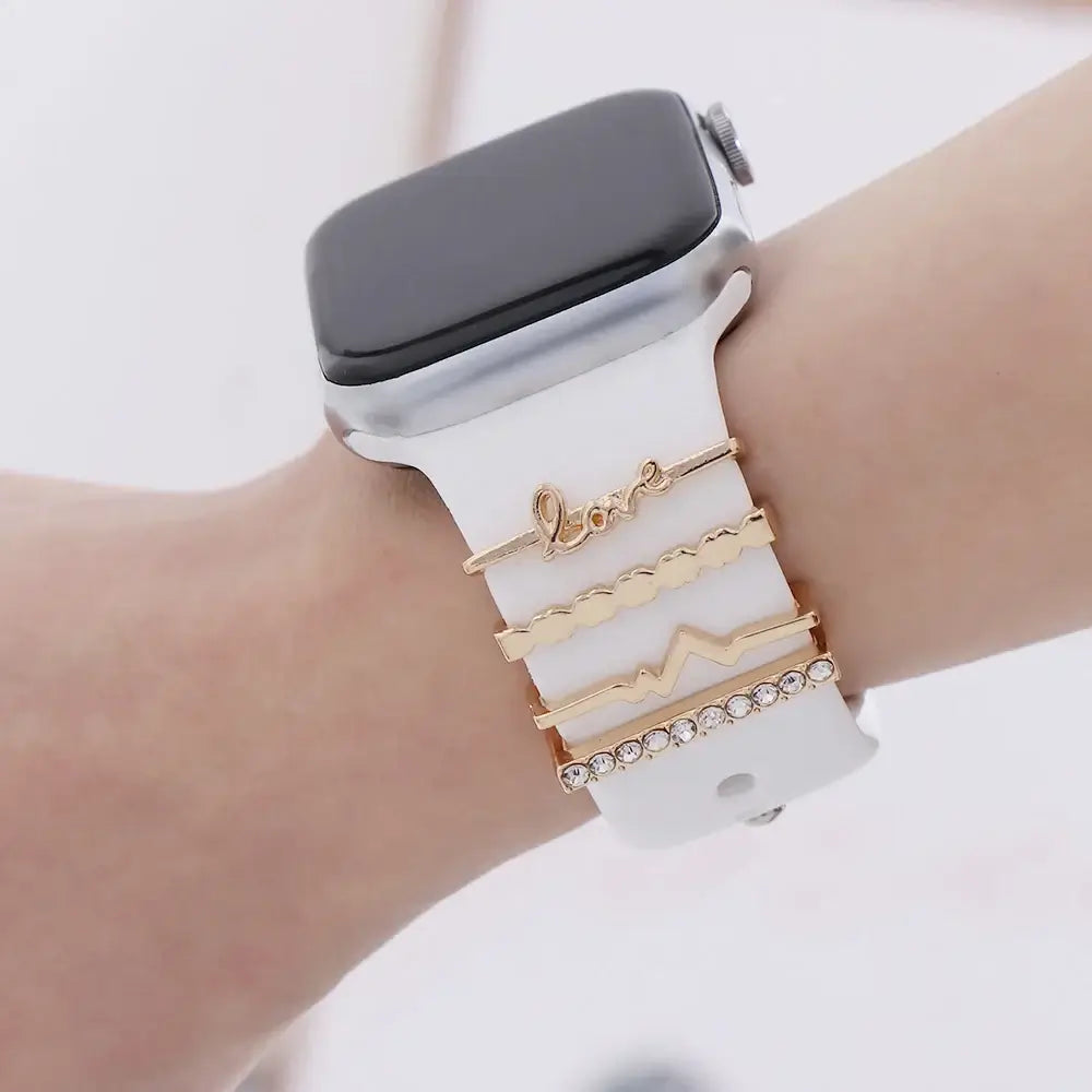 Decorative metal charms on a white Apple Watch band, enhancing style and sophistication for your smartwatch.