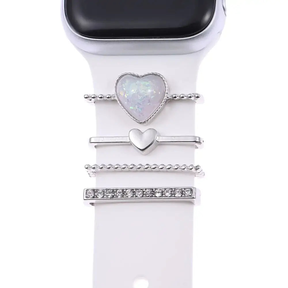 Decorative metal charms on an Apple Watch band, featuring heart designs and sparkling details for stylish sophistication.