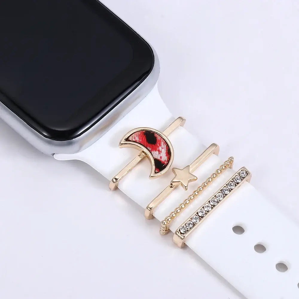 Stylish decorative metal charms on a white Apple Watch band, featuring a moon and star design. Perfect for elevating your smartwatch.