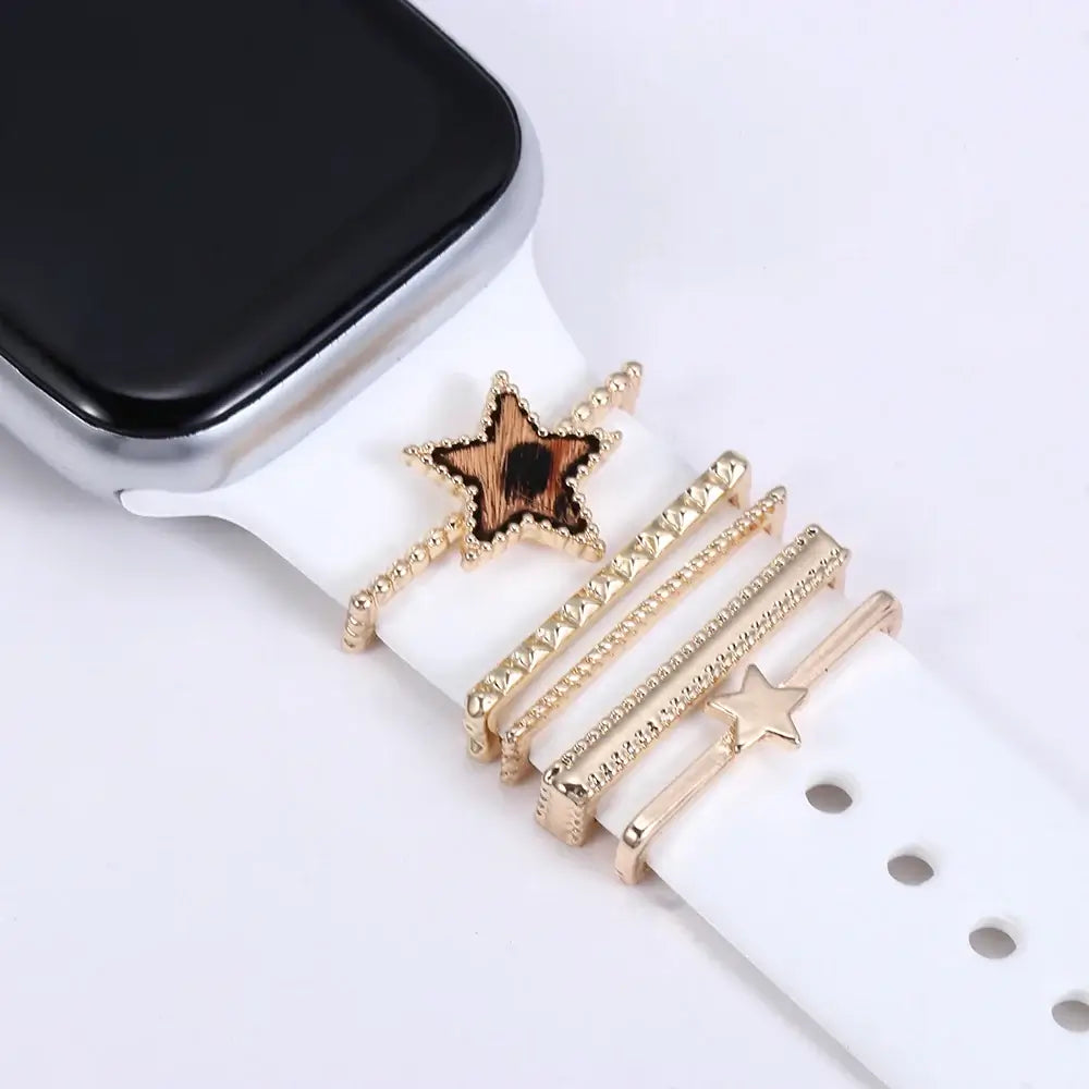Decorative metal charms on an Apple Watch band, featuring stylish star designs and elegant craftsmanship.