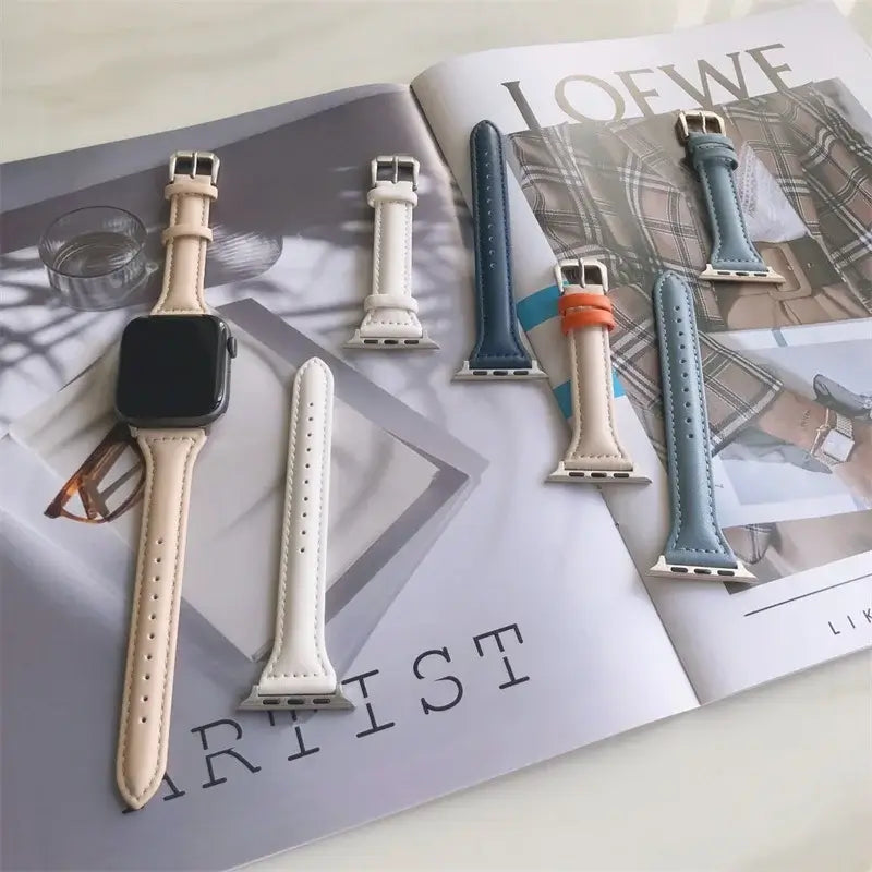 Slim leather straps for Apple Watch arranged on a magazine, showcasing various stylish colors and designs.