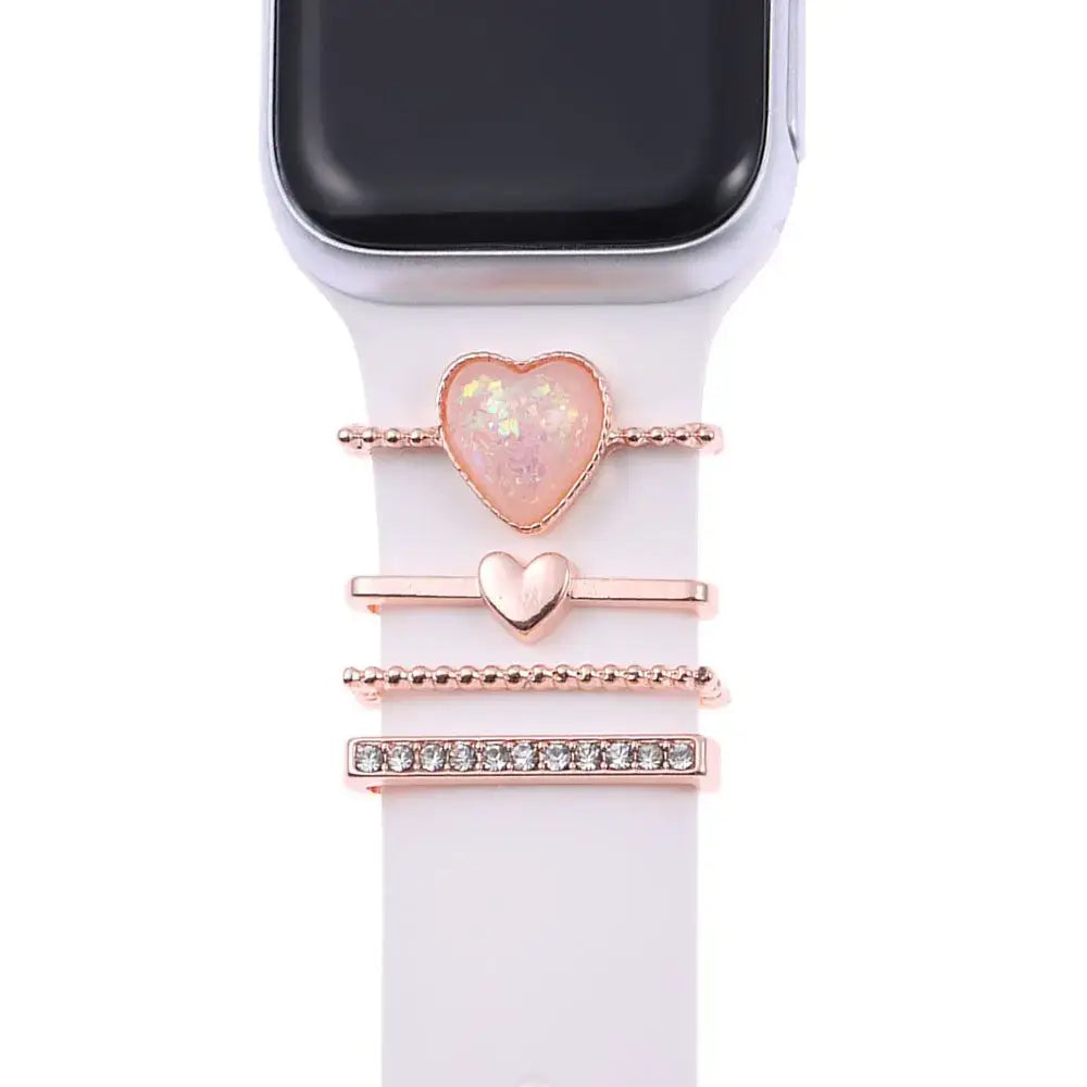 Decorative metal charms for Apple watch bands featuring heart designs in rose gold and sparkling accents.