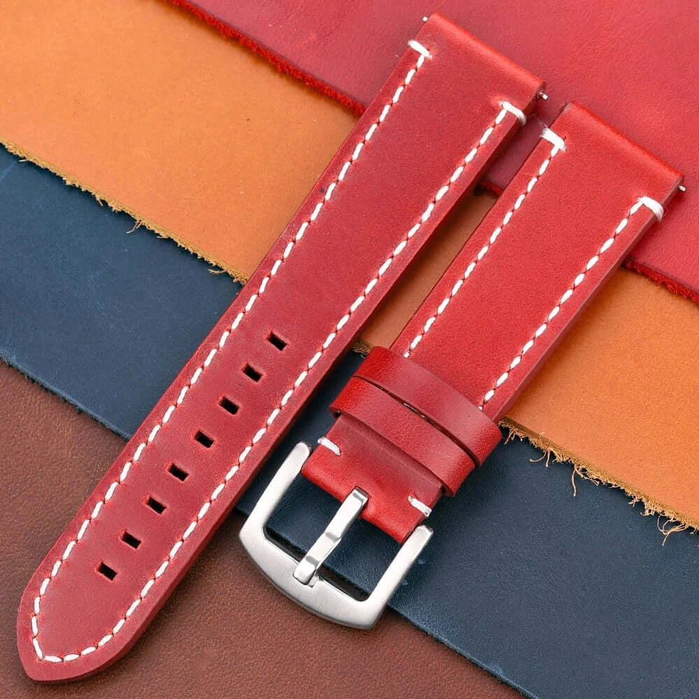 Red leather Suunto watch band with white stitching, durable design for active lifestyles, shown on leather swatches.