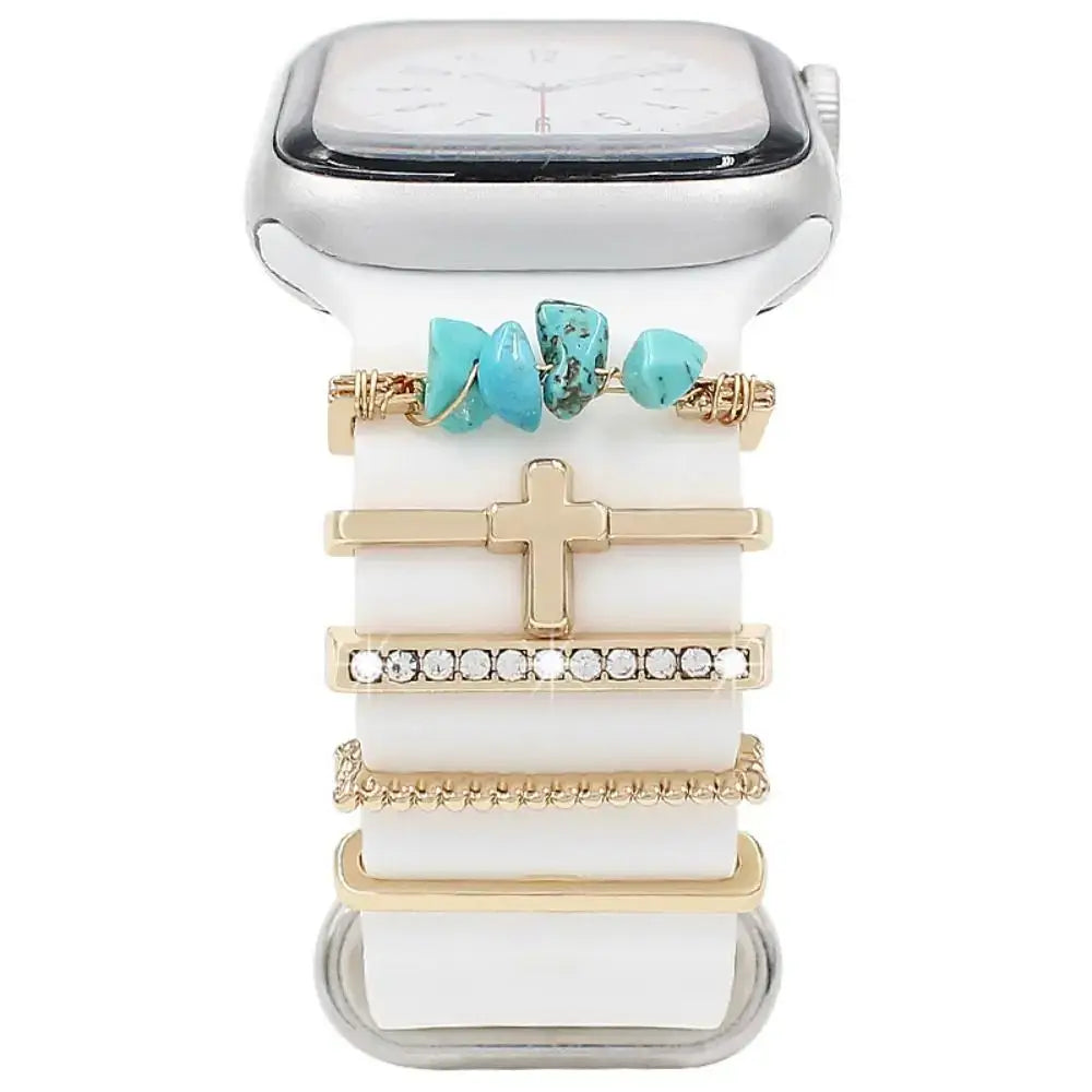 Decorative metal charms on a white Apple Watch band, adding elegance and style to your smartwatch experience.