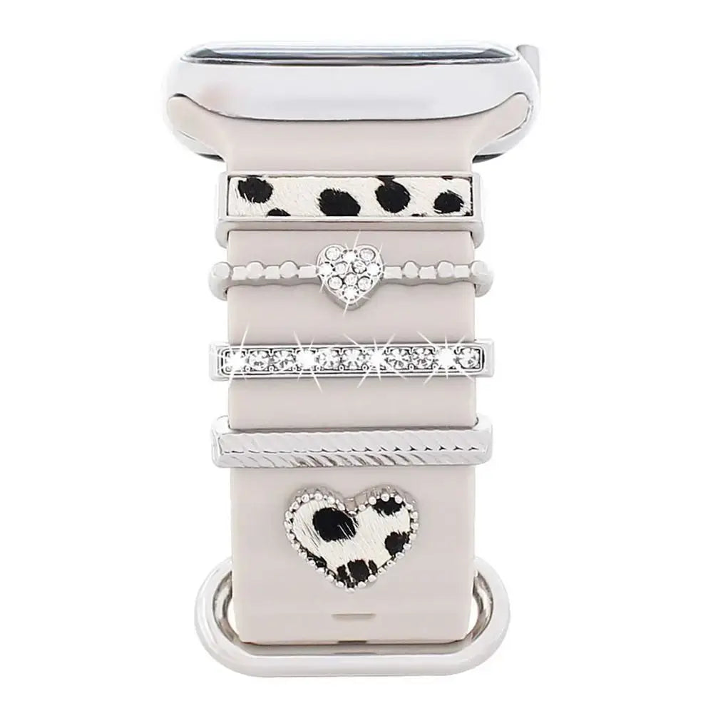 Elegant decorative metal charms on an Apple Watch band, showcasing stylish designs and sophisticated aesthetic.