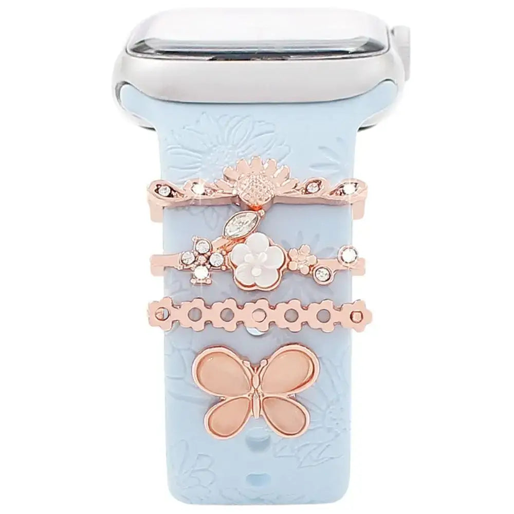 Decorative metal charms for Apple Watch bands featuring floral designs and a butterfly accent, enhancing style and sophistication.