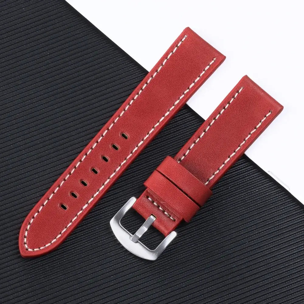 Red leather Suunto watch band with white stitching, featuring a silver buckle, perfect for smartwatch transformation.