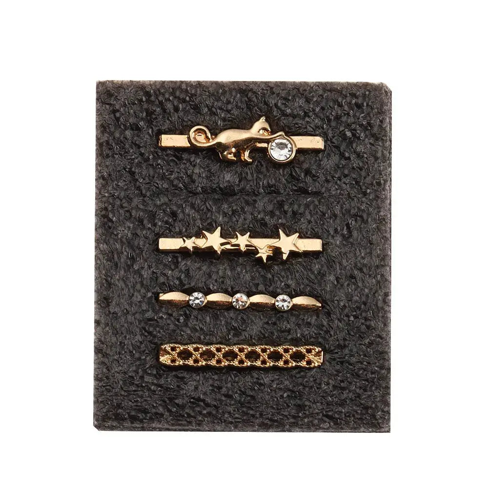 Decorative gold metal charms for Apple Watch bands featuring stars and a cat design on a black display.