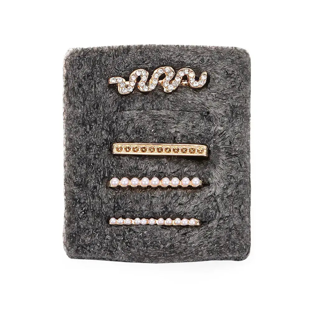 Decorative metal charms for Apple Watch bands featuring sparkling designs and pearl accents on a stylish display.