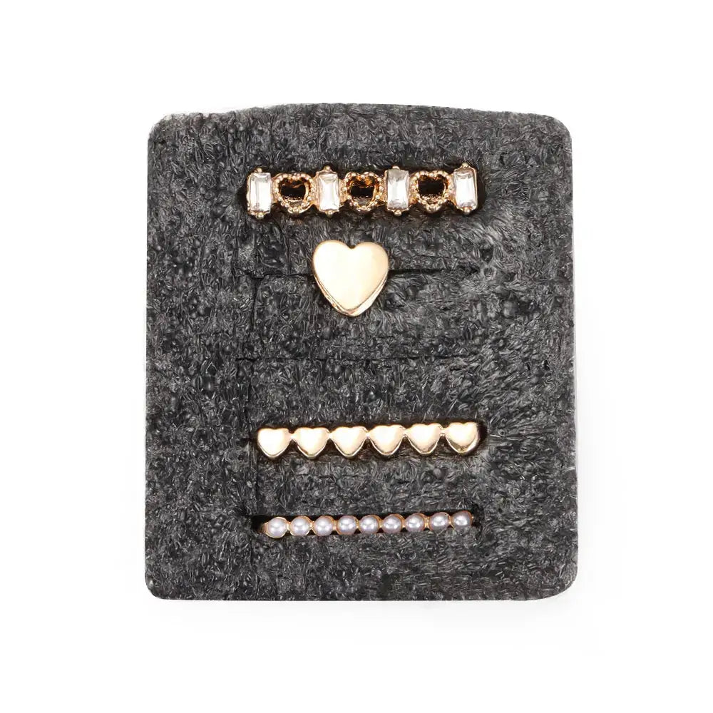 Decorative metal charms for Apple bands in gold, featuring heart and pearl designs on a plush background.