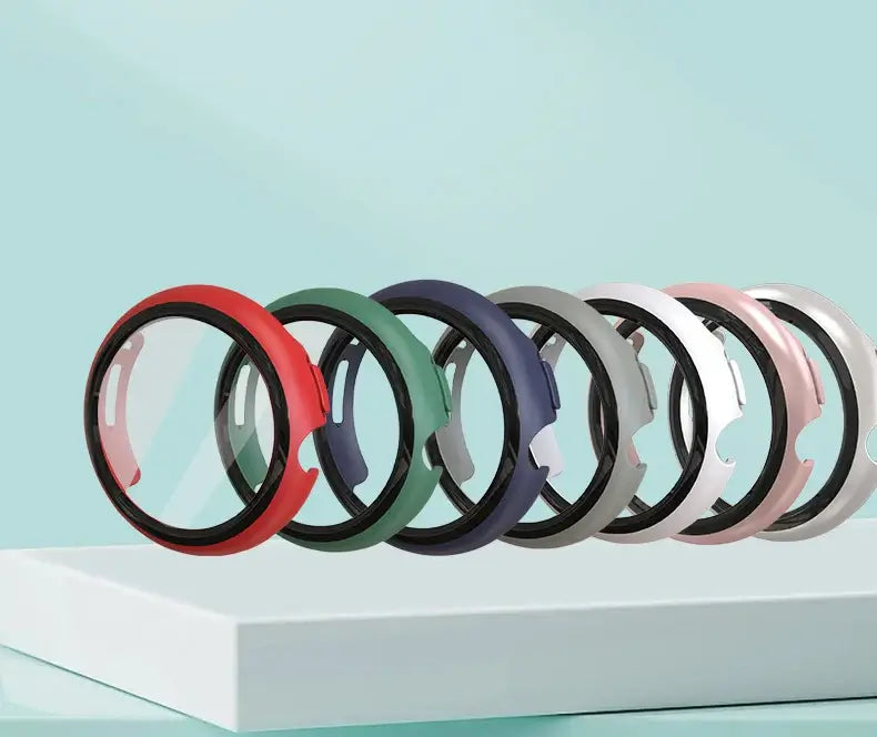 Colorful protective cases for Google Pixel Watches in red, green, blue, gray, and pink, displayed on a modern surface.
