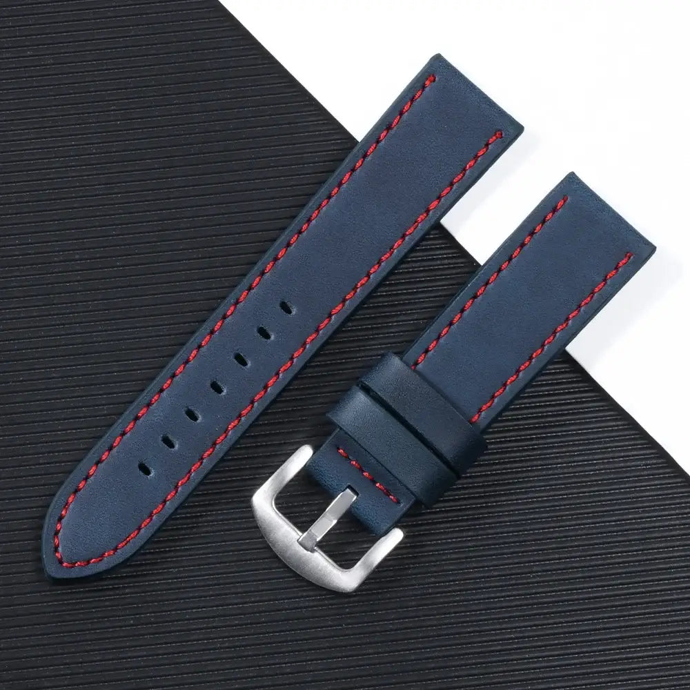 Navy leather Suunto watch band with red stitching and stainless steel buckle, ideal for modern smartwatch style.