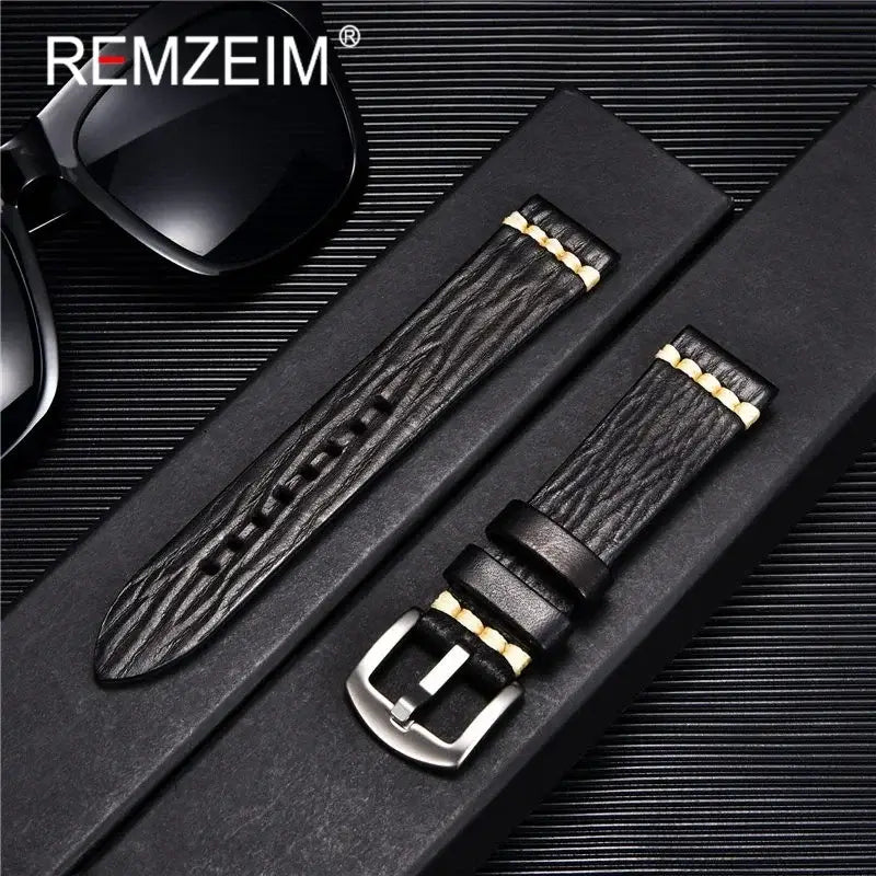 Stylish black textured leather watch band with gold accents, perfect for Suunto watches, showcased with sunglasses.