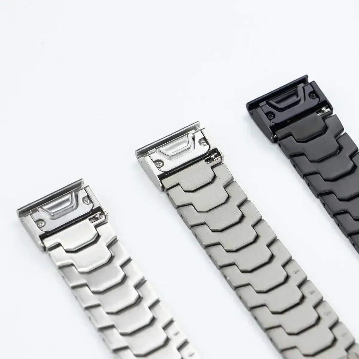 Stainless steel Garmin QuickFit bands in silver, gunmetal, and black, showcasing durability and style.