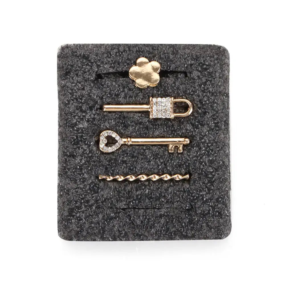 Decorative metal charms for Apple Watch bands featuring flower, lock, and key designs in gold.