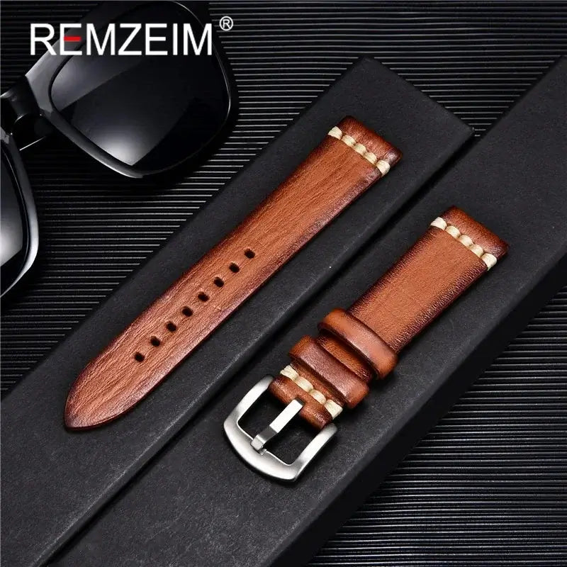 Stylish brown leather Suunto watch band displayed with sunglasses on a sleek black background.