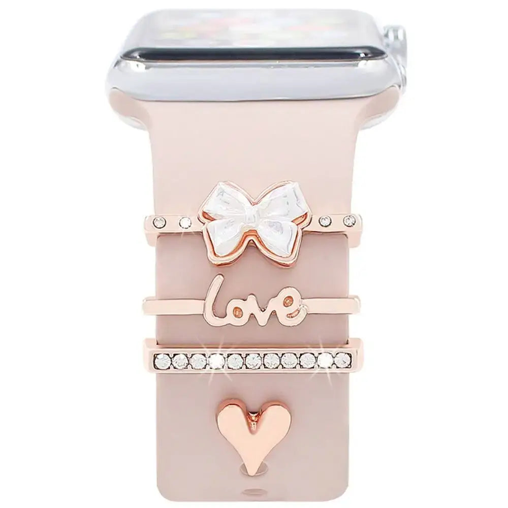 Decorative metal charms for Apple Watch bands in rose gold, featuring bow, love, and heart designs. Elevate your style!