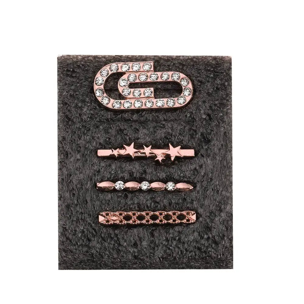 Set of decorative metal charms for Apple Watch bands, featuring rose gold designs with stones and unique shapes.