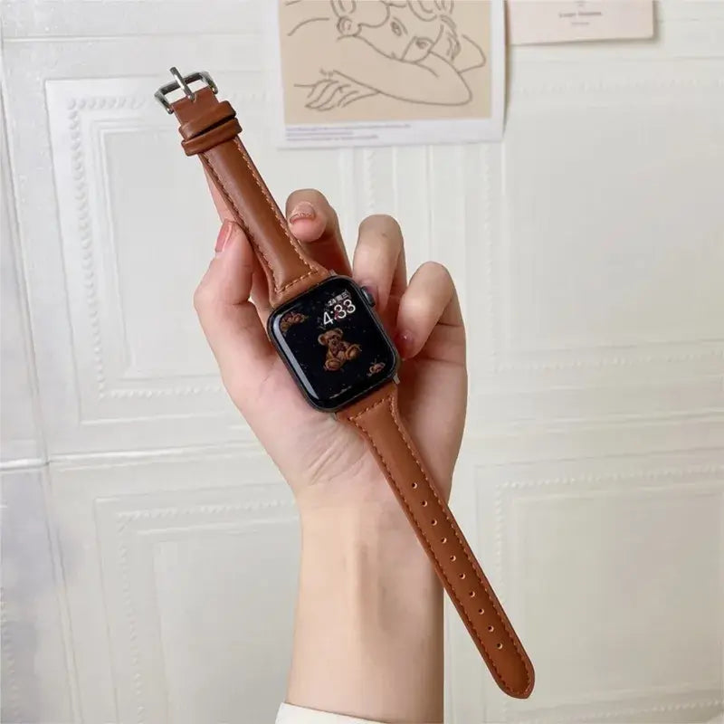 Slim brown leather strap for Apple Watch, showcasing a stylish and durable design. Perfect for modern sophistication.