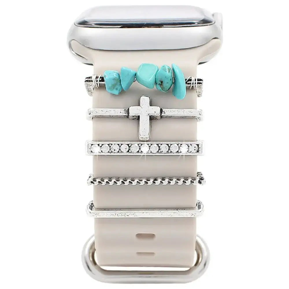 Decorative metal charms for Apple Watch bands, featuring turquoise and silver designs, enhancing smartwatch style.