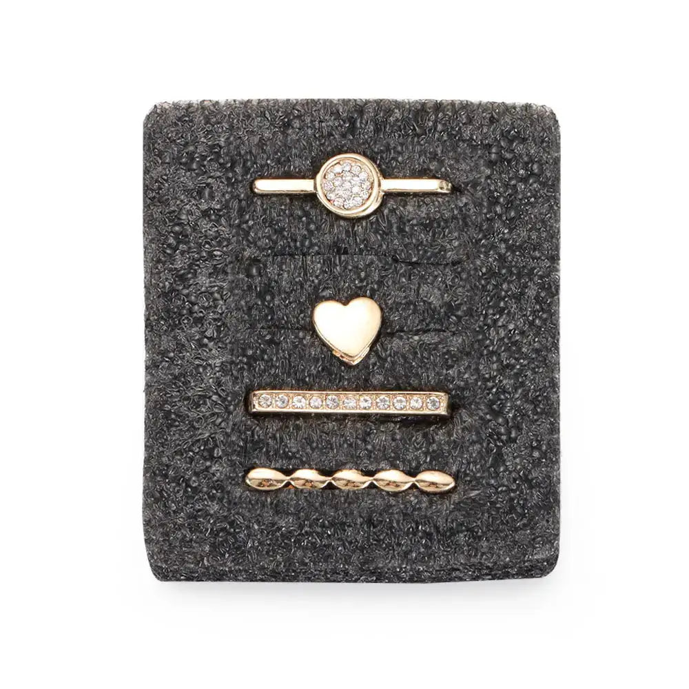Decorative metal charms for Apple Watch bands in gold, including sparkling circle, heart, and bead designs.