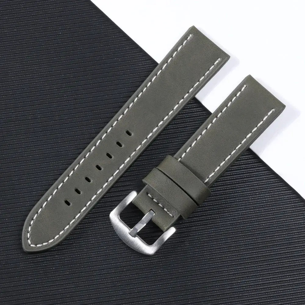 Olive green leather watch band with white stitching and silver buckle, perfect for Suunto smartwatches.