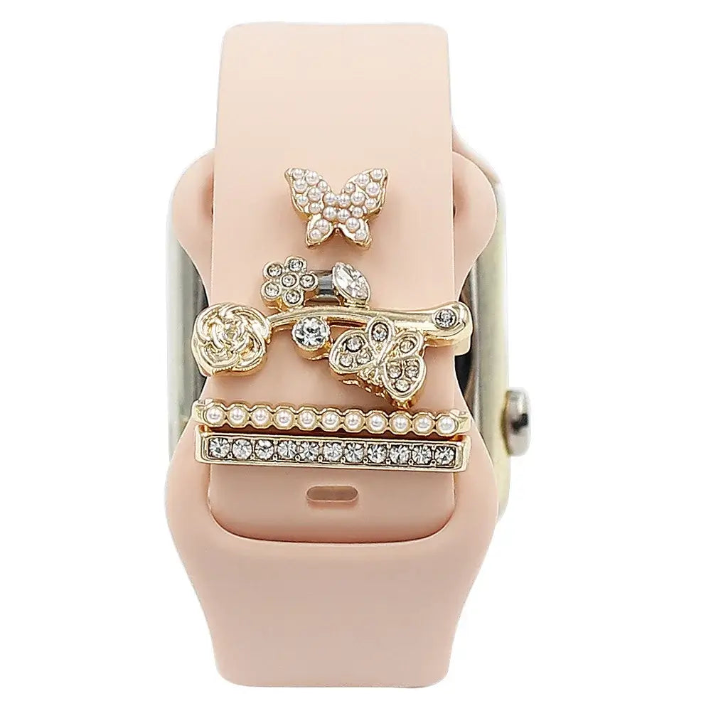Decorative metal charms on a pink Apple Watch band, adding elegance and sophistication to your smartwatch style.