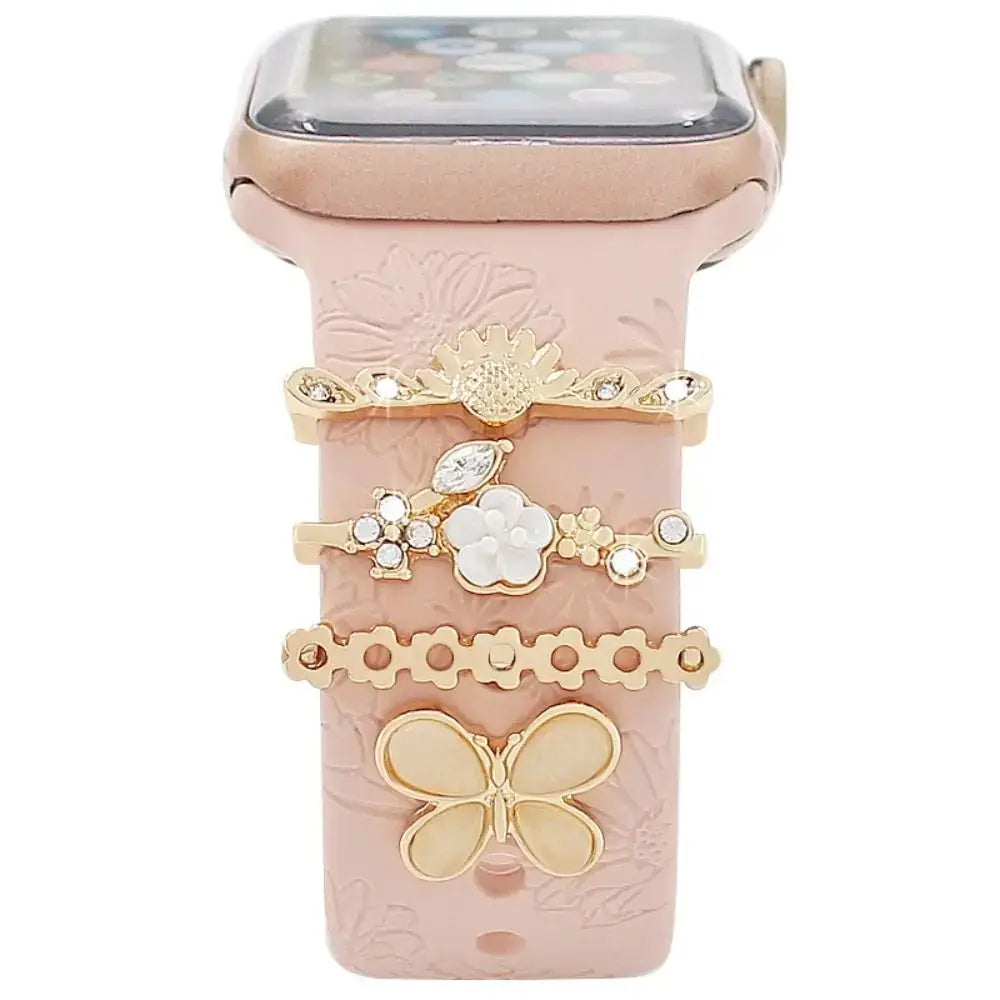 Decorative metal charms for Apple Watch bands in elegant gold design, enhancing style and sophistication.