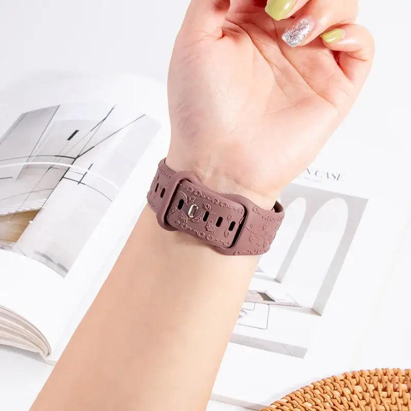 Flower engraved pink Apple Watch strap worn on wrist, showcasing stylish design and quality craftsmanship.