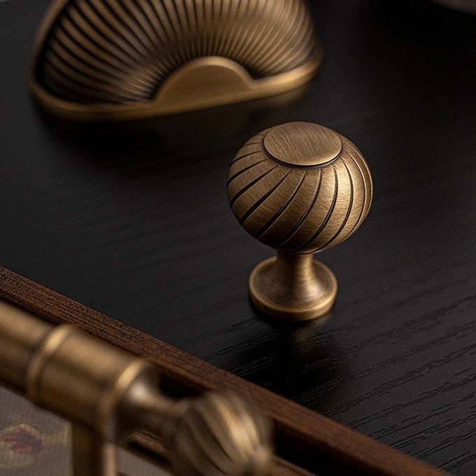 Ribbed solid brass ball cabinet knob in antique brass