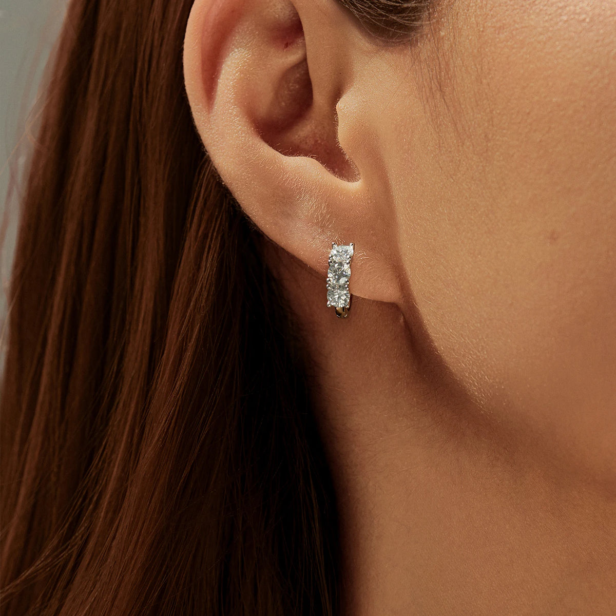 Round Moissanite Huggie Hoop Earrings in Sterling Silver — Huggie hoop worn
