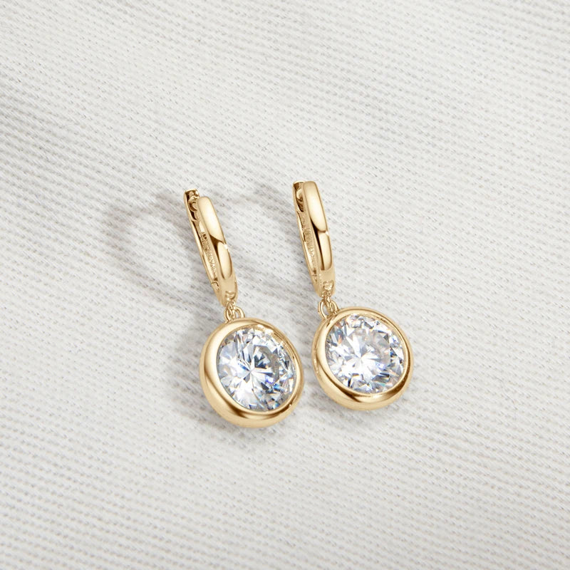 Bezel Moissanite Hoop Drop Earrings in 925 Sterling Silver — Gold-tone pair on fabric