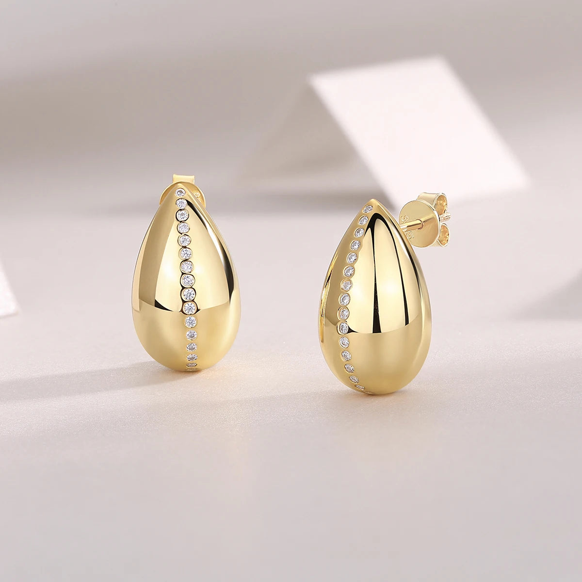 Gold-Plated Teardrop Moissanite Accent Stud Earrings — Gold-tone teardrop pair