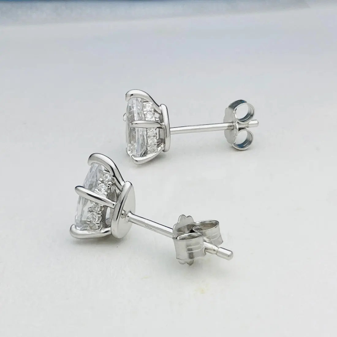Pear Moissanite Stud Earrings in Sterling Silver — Post and basket detail