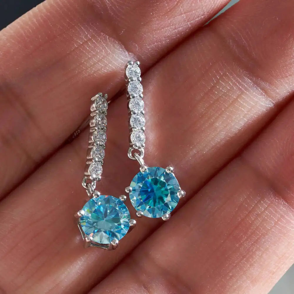Colorful Moissanite Bar Drop Earrings in Sterling Silver — Sea Blue drops held for scale