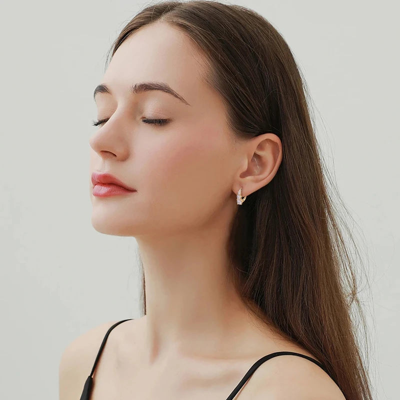 Graduated Four-Stone Moissanite Leverback Earrings — Leverback earrings worn on the ear
