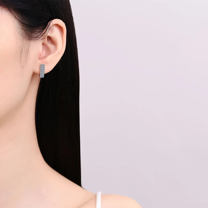 Pavé Moissanite Huggie Hoop Earrings in Sterling Silver — Worn on ear