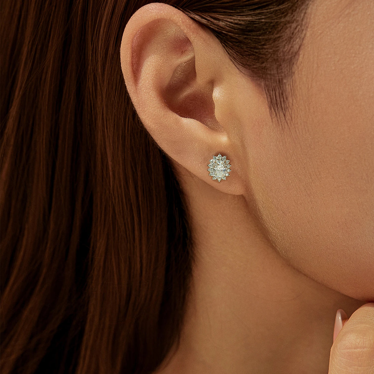 Oval Moissanite Floral Halo Stud Earrings in Sterling Silver - Floral halo earrings on model