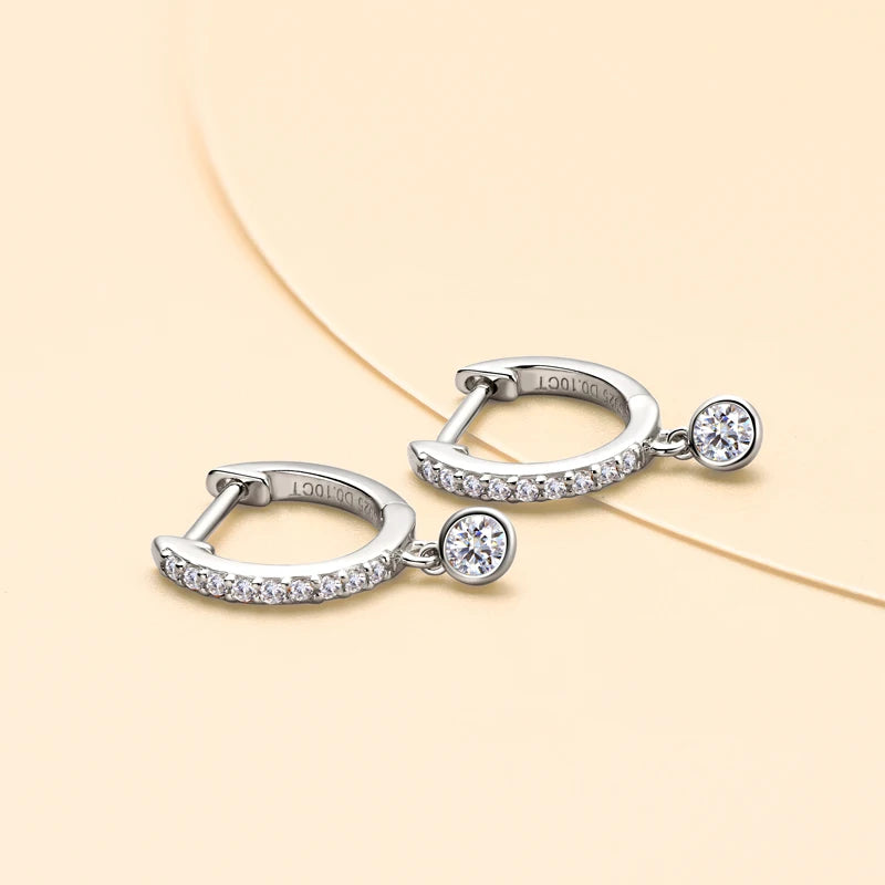 Bezel Drop Moissanite Huggie Earrings in Sterling Silver — Silver pair laid flat