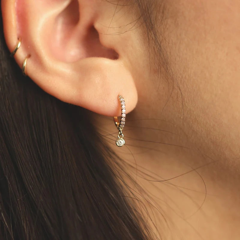 Bezel Drop Moissanite Huggie Earrings in Sterling Silver — Silver hoop worn on the ear
