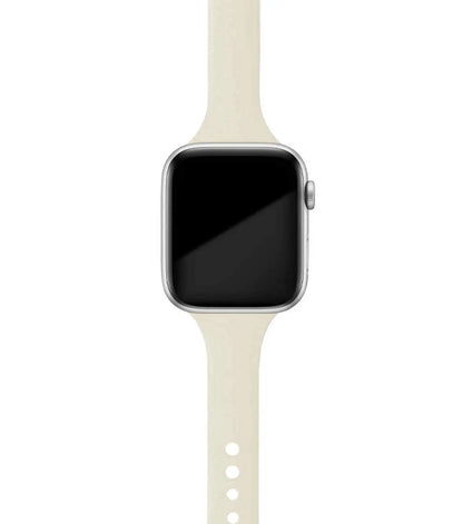 Apple Watch with soft beige silicone band, designed for comfort and versatility in everyday wear.