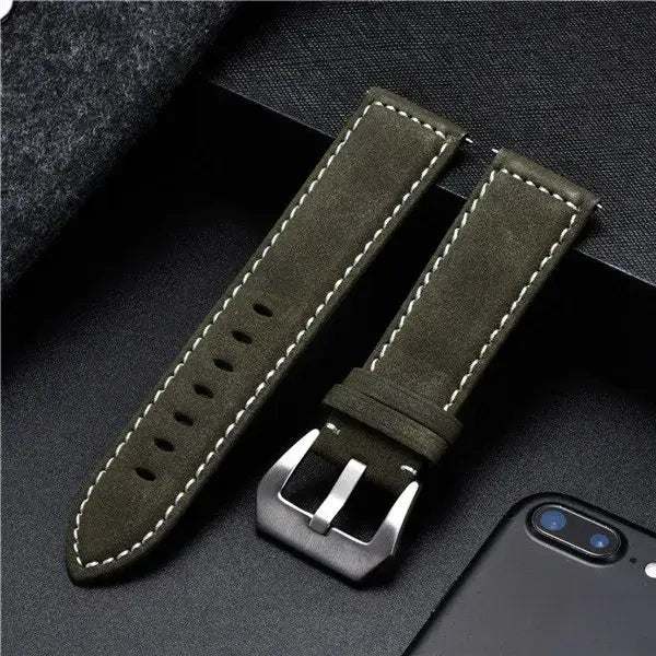 Durable green leather Suunto watch band with white stitching and metal buckle, perfect for daily challenges.