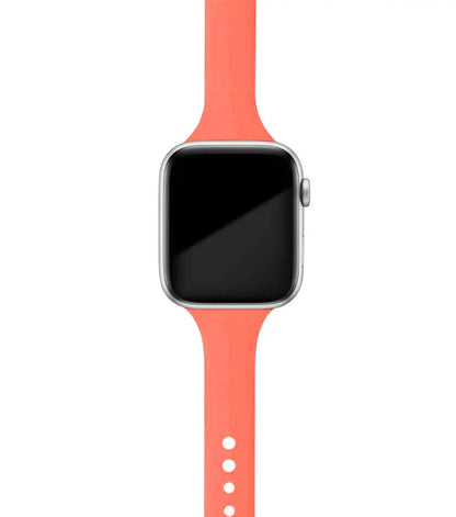 Apple Watch with a soft coral silicone band, designed for comfort and versatility, perfect for everyday wear.