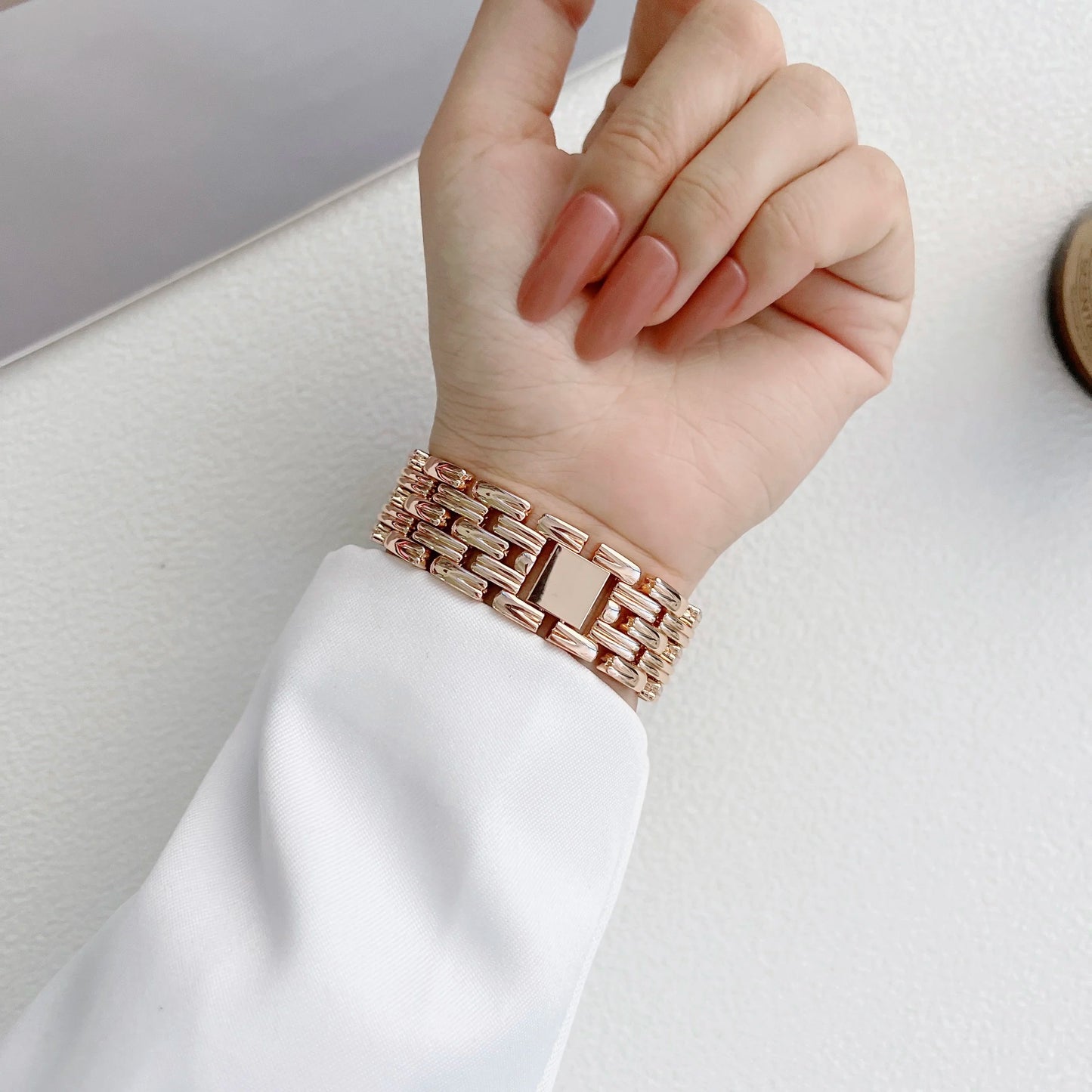 Elegant Apple Watch stainless steel band with luxury diamond design worn on a hand, showcasing its stylish look.