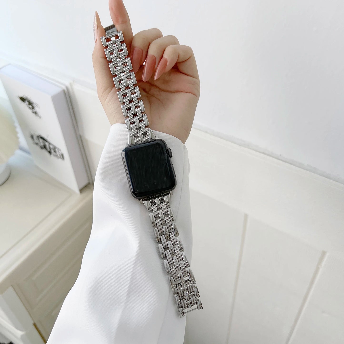 Apple Watch with stainless steel band featuring luxury diamond design, showcased elegantly on a wrist.